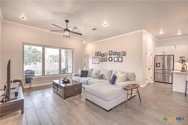 living room featuring crown molding and ceiling fan