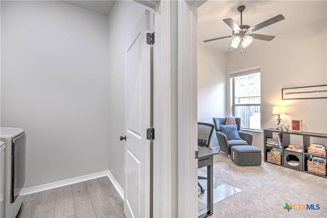 interior space with ceiling fan, washer and clothes dryer, and light wood-type flooring