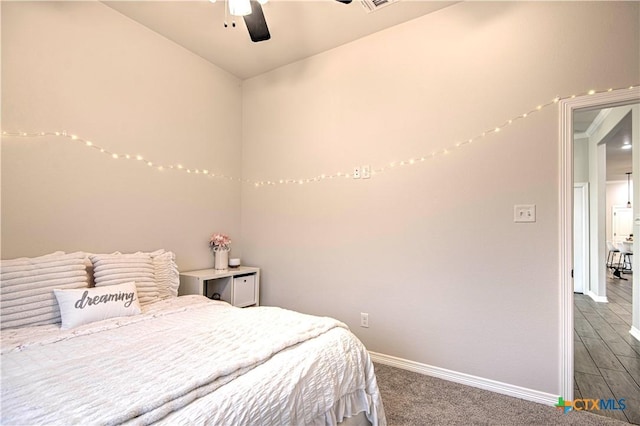 carpeted bedroom featuring lofted ceiling and ceiling fan