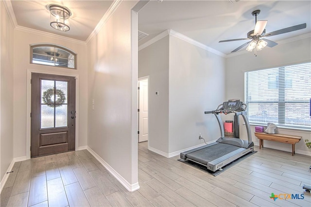 entrance foyer featuring ceiling fan, ornamental molding, and light wood-type flooring