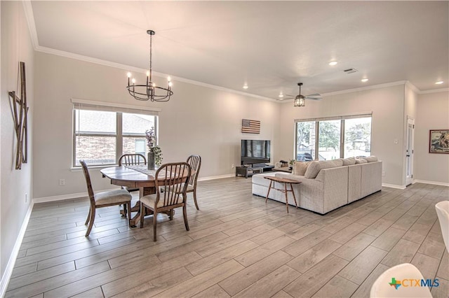 dining space featuring ornamental molding and ceiling fan with notable chandelier