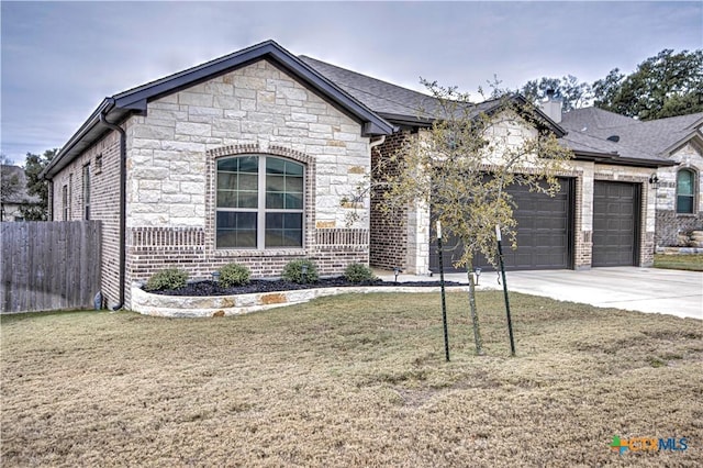 view of front of property with a garage and a front yard