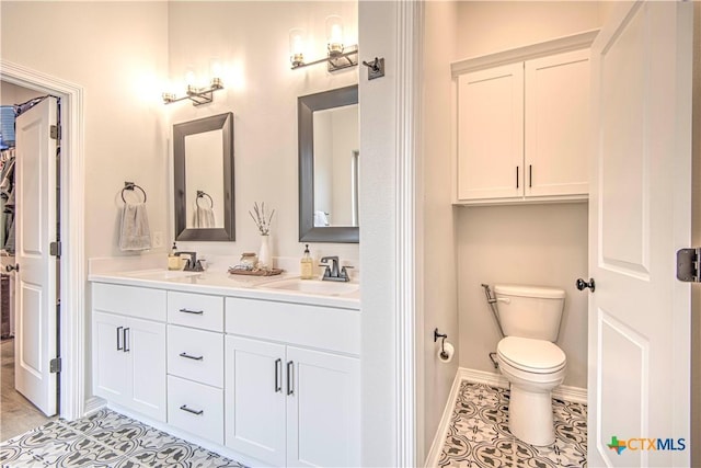 bathroom featuring vanity, toilet, and tile patterned flooring