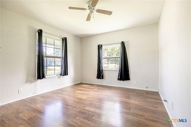 123 Burnet St, Port Lavaca, TX 77979 - spare room featuring wood finished floors, ceiling fan, and baseboards