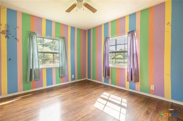 123 Burnet St, Port Lavaca, TX 77979 - unfurnished room with plenty of natural light, wood finished floors, ceiling fan, and baseboards