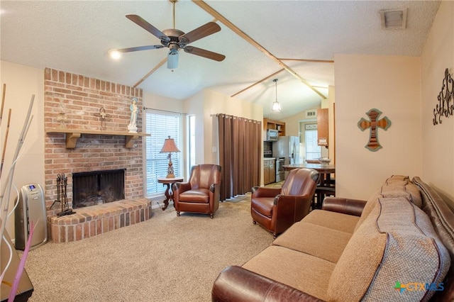 505 Cabana Dr, Victoria, TX 77901 - carpeted living area with lofted ceiling, a ceiling fan, a textured ceiling, and a fireplace