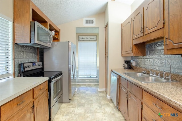 505 Cabana Dr, Victoria, TX 77901 - kitchen with stainless steel appliances, decorative backsplash, lofted ceiling, light countertops, and open shelves