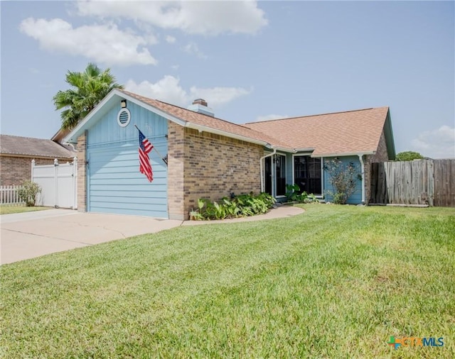 505 Cabana Dr, Victoria, TX 77901 - view of front facade with concrete driveway, an attached garage, brick siding, and a chimney
