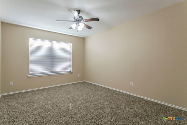 unfurnished room featuring carpet floors, a ceiling fan, and baseboards