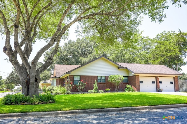 single story home featuring a garage and a front yard