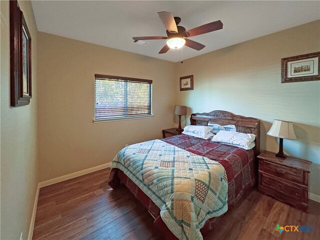 bedroom with dark wood-type flooring and ceiling fan