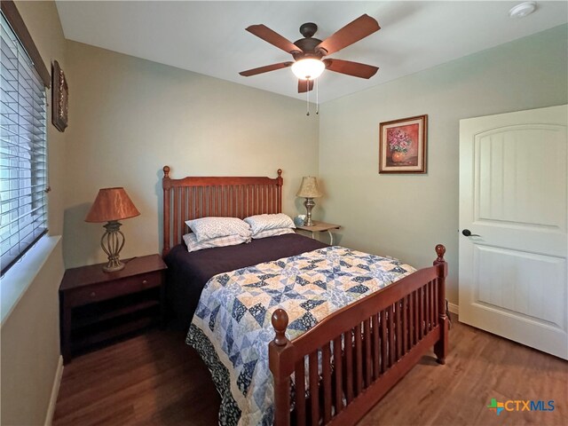 bedroom with ceiling fan and dark hardwood / wood-style floors