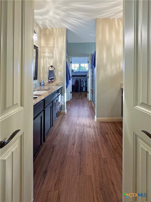 hall featuring dark hardwood / wood-style floors and sink