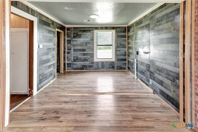 116 N Ben Wilson St, Victoria, TX 77901 - unfurnished room featuring wood walls and wood finished floors