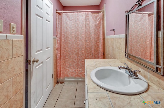 116 N Ben Wilson St, Victoria, TX 77901 - full bath with tile walls, vanity, a wainscoted wall, tile patterned flooring, and curtained shower