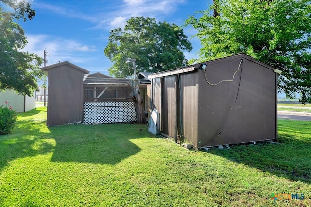 116 N Ben Wilson St, Victoria, TX 77901 - view of green lawn featuring a storage shed