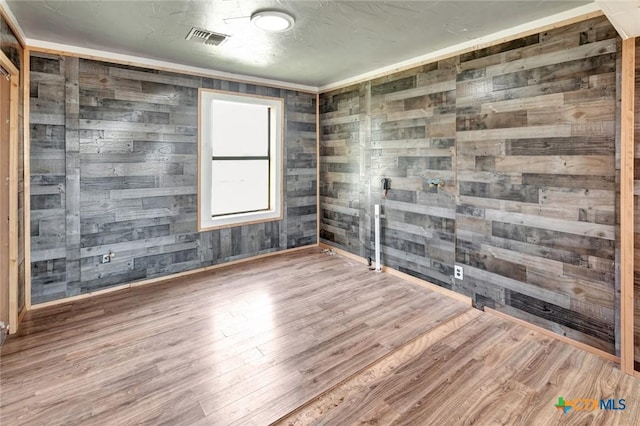 116 N Ben Wilson St, Victoria, TX 77901 - spare room with wood walls and wood finished floors