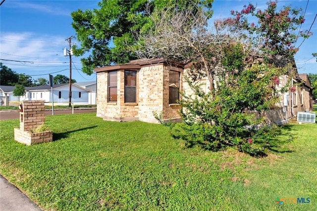 116 N Ben Wilson St, Victoria, TX 77901 - view of front facade with brick siding and a front lawn