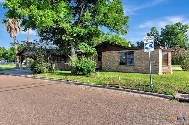 116 N Ben Wilson St, Victoria, TX 77901 - view of front of home featuring a front yard and brick siding