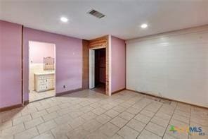 116 N Ben Wilson St, Victoria, TX 77901 - tiled spare room featuring recessed lighting