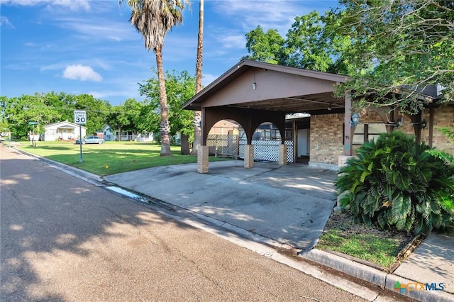116 N Ben Wilson St, Victoria, TX 77901 - view of property's community featuring a carport, driveway, and a yard