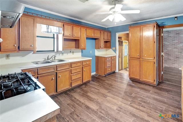 116 N Ben Wilson St, Victoria, TX 77901 - kitchen featuring ceiling fan, dark wood-style floors, ornamental molding, brown cabinets, and gas range oven