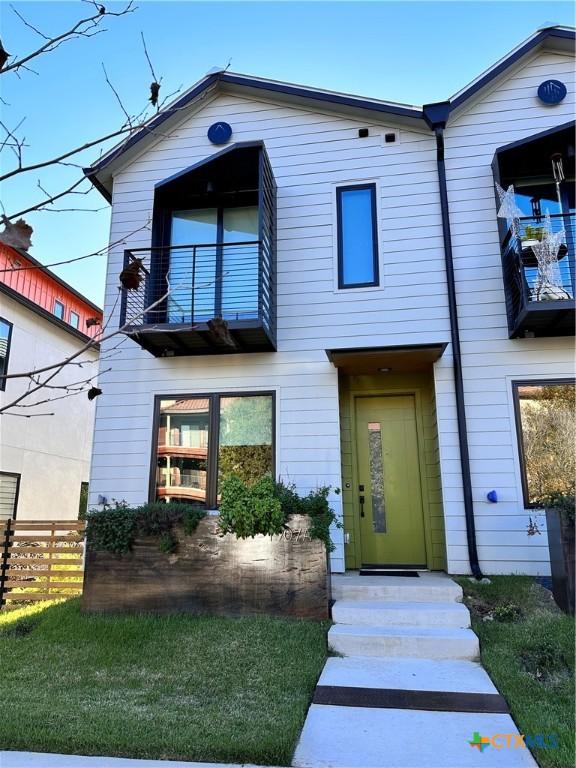 view of front of home with a balcony