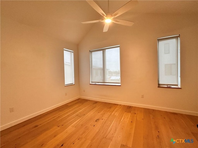 spare room with ceiling fan, light hardwood / wood-style floors, and vaulted ceiling