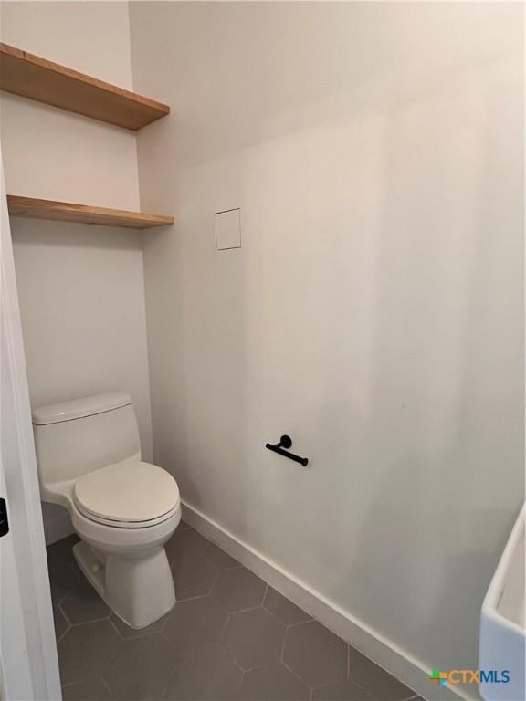 bathroom with tile patterned floors and toilet