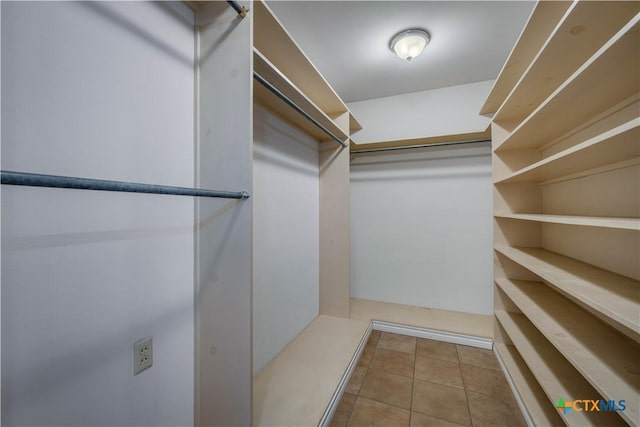 spacious closet with tile patterned floors