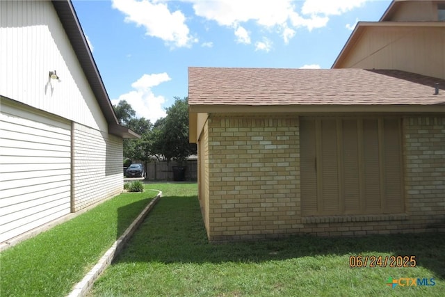 2101 Stagecoach Trl, Temple, TX 76502 - view of home's exterior with brick siding, roof with shingles, and a yard