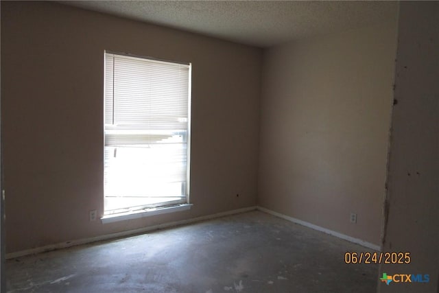 2101 Stagecoach Trl, Temple, TX 76502 - empty room featuring a textured ceiling and unfinished concrete flooring