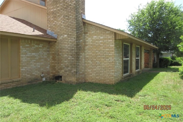 2101 Stagecoach Trl, Temple, TX 76502 - view of property exterior featuring a lawn, a chimney, brick siding, and a shingled roof