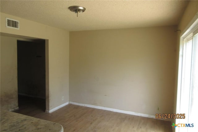 2101 Stagecoach Trl, Temple, TX 76502 - unfurnished bedroom with wood finished floors and a textured ceiling