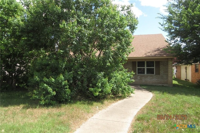 2101 Stagecoach Trl, Temple, TX 76502 - view of front of home with brick siding, roof with shingles, and a front yard