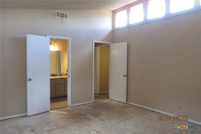2101 Stagecoach Trl, Temple, TX 76502 - unfurnished bedroom with a high ceiling and ensuite bath