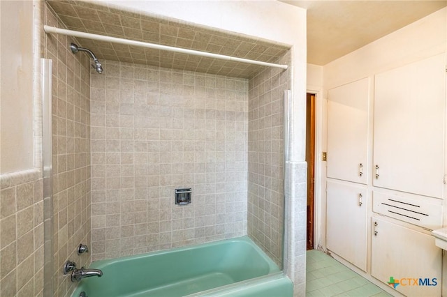 bathroom with tile patterned flooring and tiled shower / bath combo