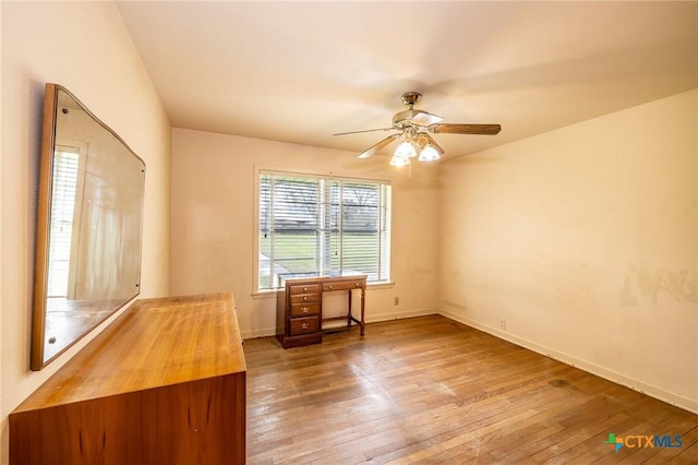 unfurnished office featuring ceiling fan and wood-type flooring