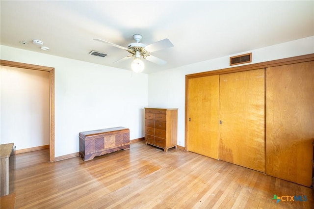 unfurnished bedroom with ceiling fan, light hardwood / wood-style floors, and a closet