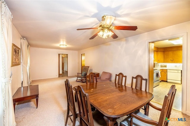 carpeted dining space featuring ceiling fan