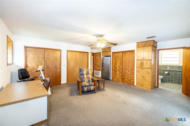 interior space featuring ceiling fan and carpet floors