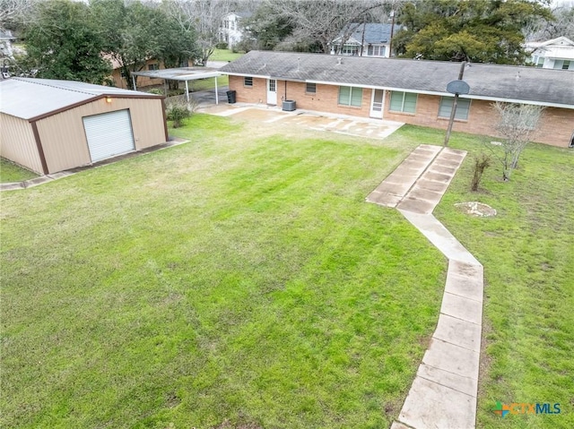 view of yard featuring an outbuilding and a carport