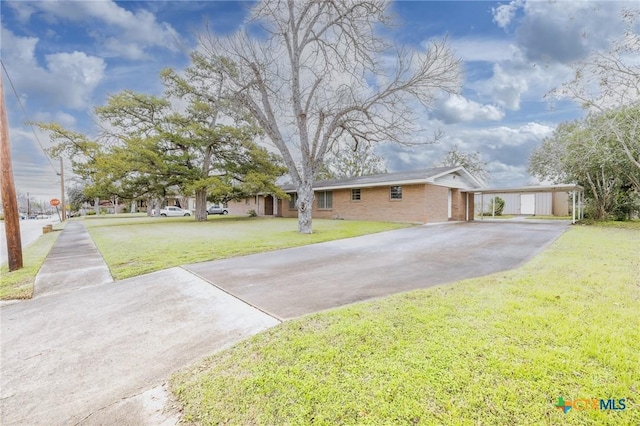 ranch-style house with a carport and a front lawn