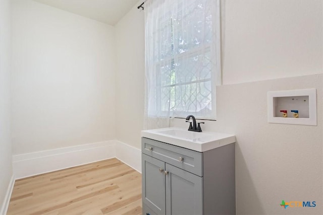 413 S Tyler St, Mcgregor, TX 76657 - laundry room featuring hookup for a washing machine and light wood-style flooring