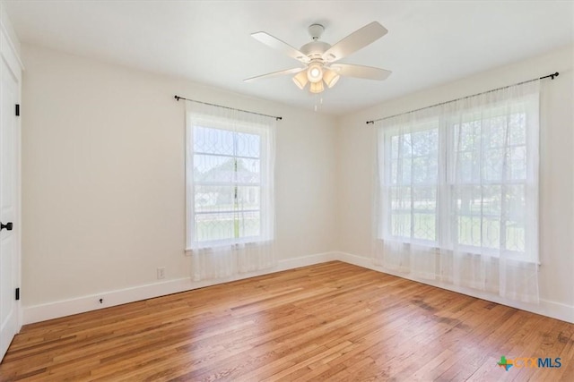 413 S Tyler St, Mcgregor, TX 76657 - spare room with wood-type flooring, healthy amount of natural light, ceiling fan, and baseboards