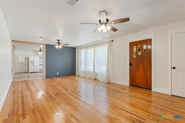 413 S Tyler St, Mcgregor, TX 76657 - unfurnished living room with a ceiling fan, baseboards, and light wood finished floors