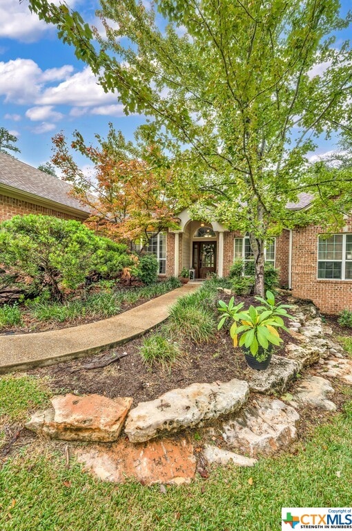 view of property hidden behind natural elements