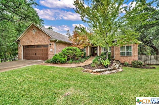 view of front of house with a front yard and a garage