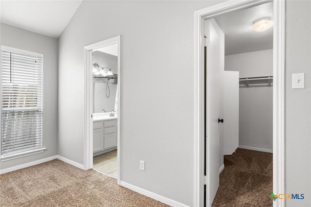 interior space featuring light colored carpet and vaulted ceiling