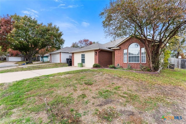 ranch-style home with a garage and a front lawn